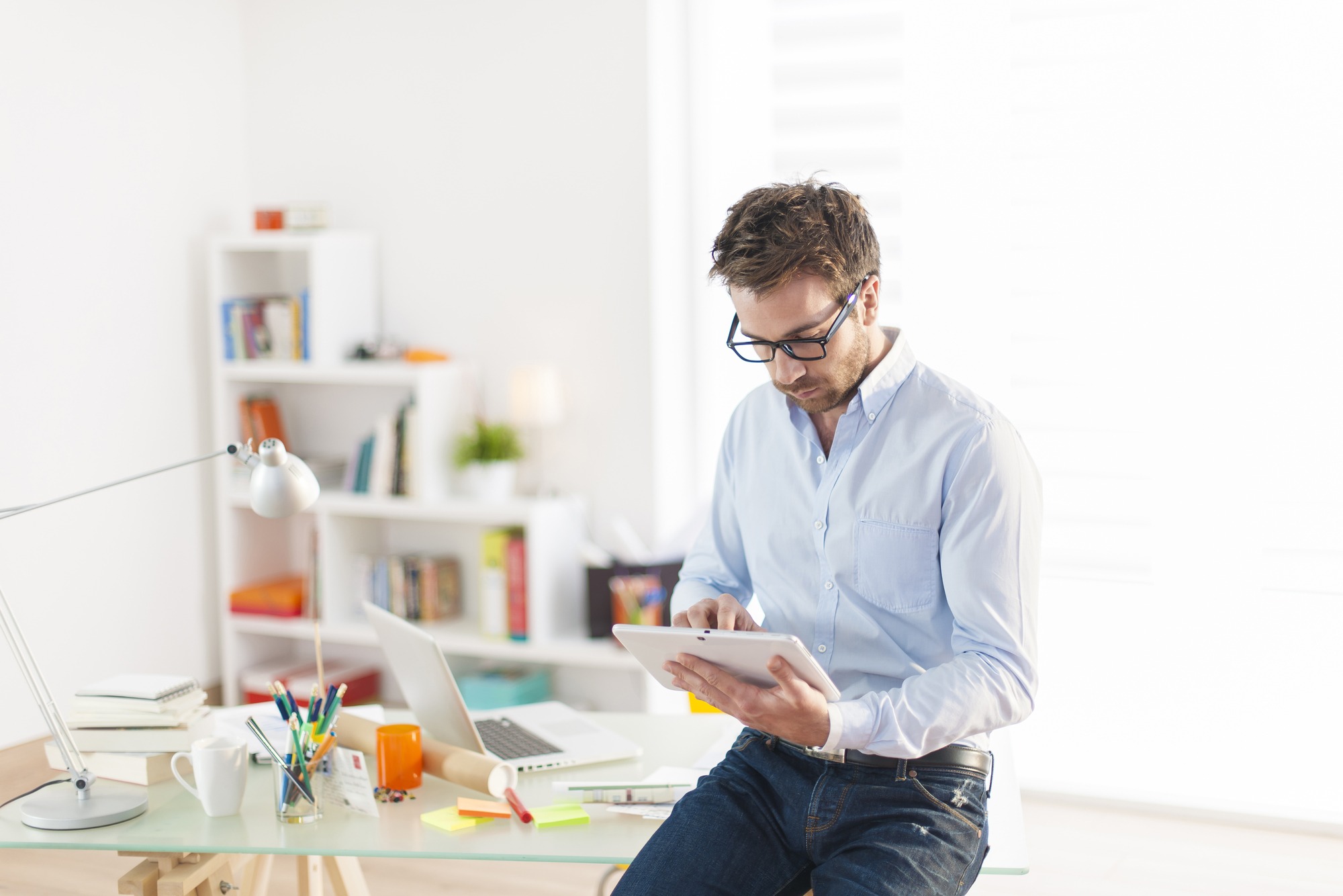 Young man using a digital tablet at office